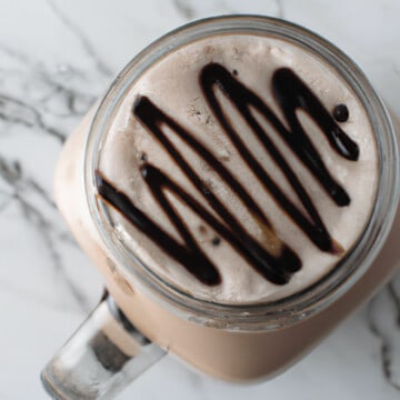 espresso mocha in a glass jar with chocolate squiggles on top