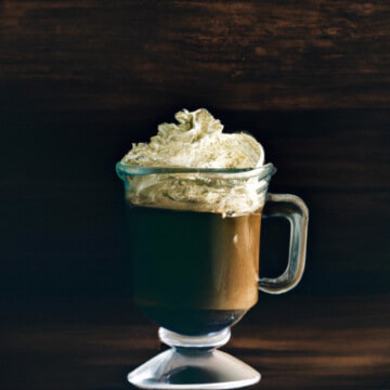 coffee nudge in an irish coffee glass, with whipped cream on top